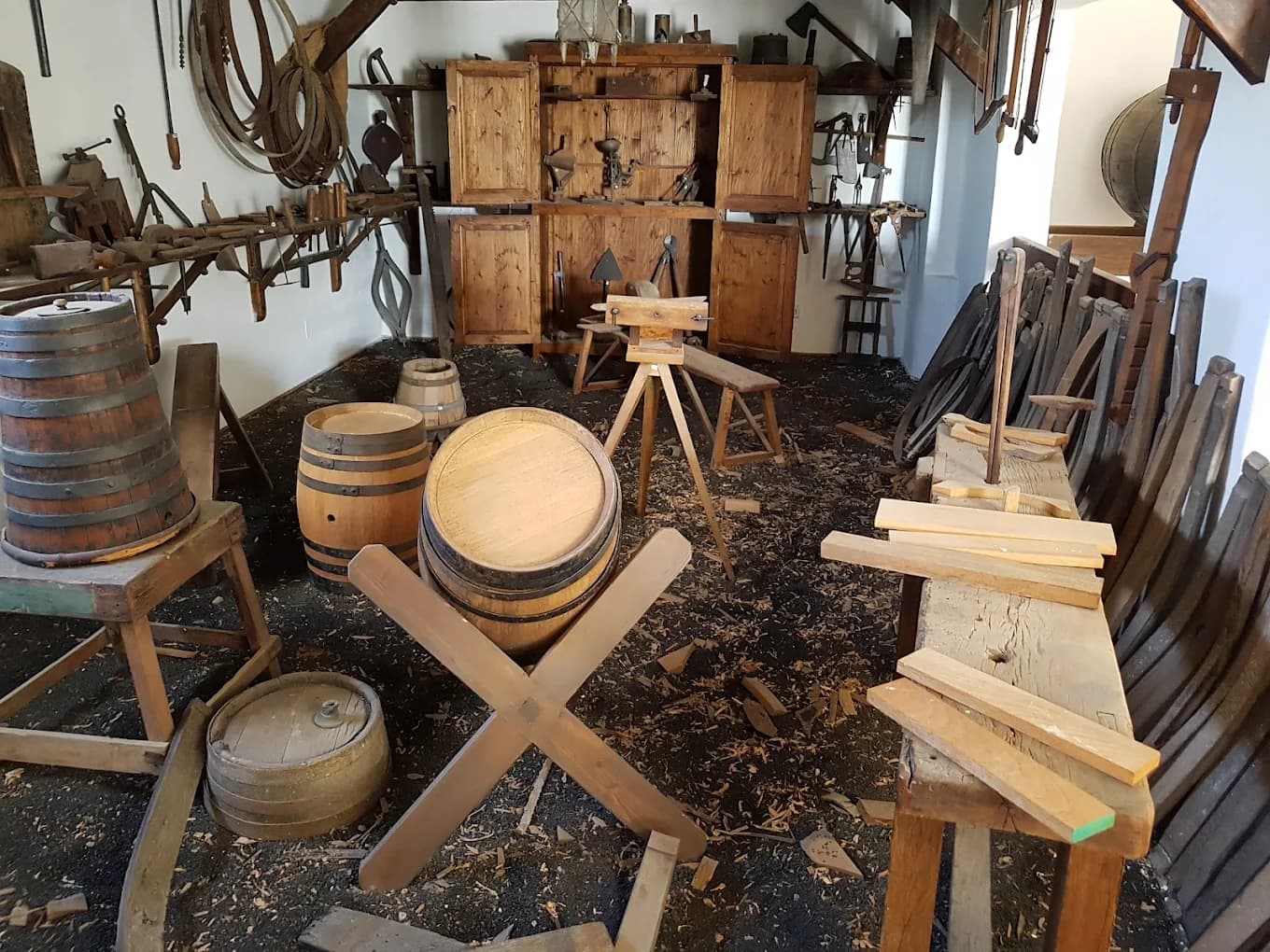 Wine barrels aging inside a traditional Lanzarote bodega cellar